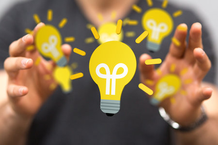 A 3D rendering light bulb icon floating on a man's hand - new idea conceptの写真素材