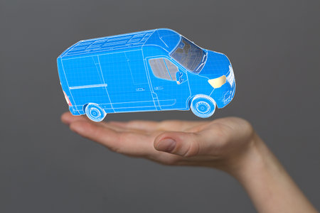 A male hand with a 3D rendered truck over it -  logistics and delivery conceptの写真素材