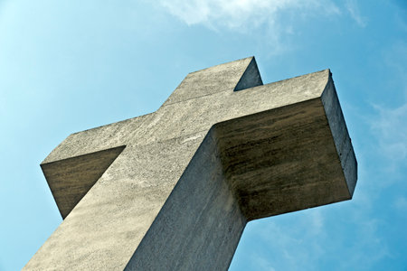 A large cross and blue sky from the worm's-eye view.の写真素材