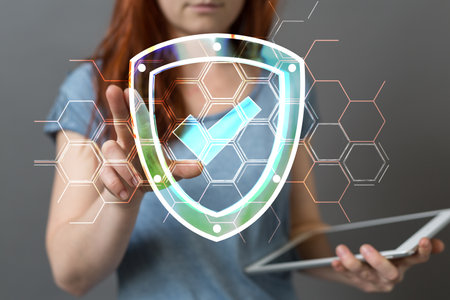 A woman tapping on a 3d rendering of a verified cyber security hologramの写真素材