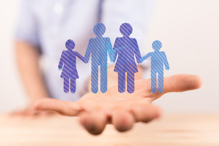 A hologram of a family floating on a person's handの写真素材