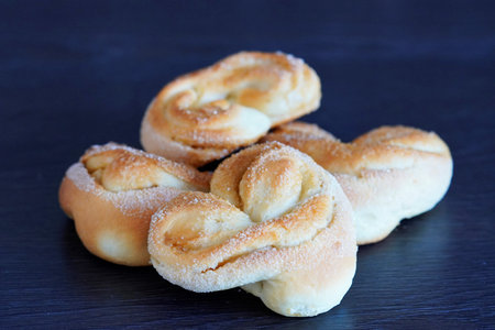 A closeup shot of pastries made from yeast dough with sugar sprinklesの写真素材