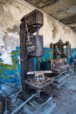 An Abandoned rusty pressing machine at an abandoned factoryの写真素材