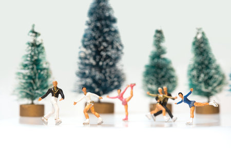 A group of miniature figures of ice skaters on a white background