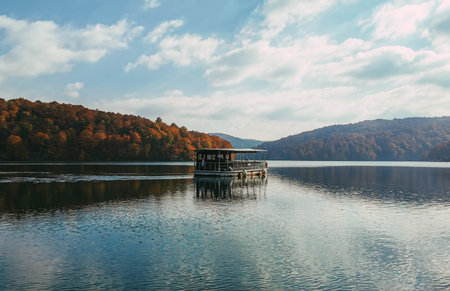 A tourist boat in the lake at famous Plitvice Lakes National Park in Croatia in autumn