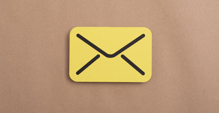 A yellow paper message symbol on a pastel background