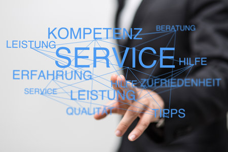A 3D rendering of a man pointing at floatingGerman words linked with service textの写真素材