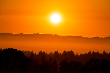 An orange sunrise over the mountains in Sonoma County, California, USAの写真素材