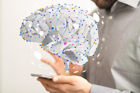 The 3D rendered brain hovering over the person's hand holding a smartphone