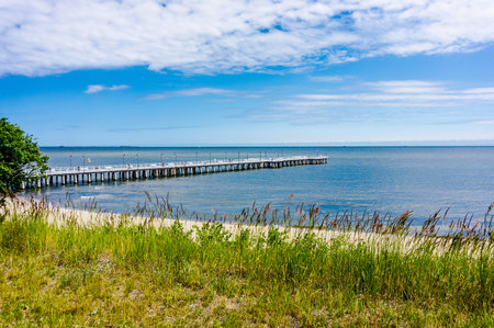 A beautiful view of the wavy sea hitting the sandy beachの写真素材
