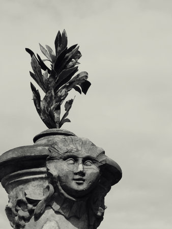 A vertical shot of beautiful architecture with a face on it in grayscale in Bayreuth, Fichtelgebirge