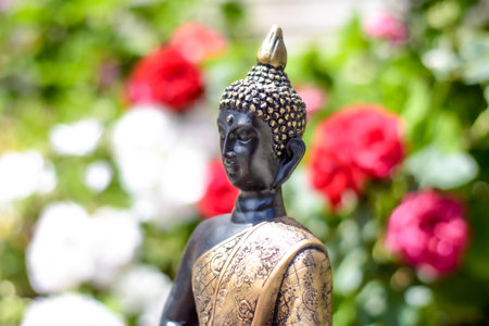 A closeup of the statue of Buddha against the background of the garden.の写真素材