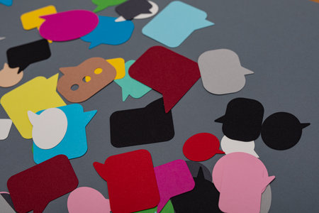 A table with many colorful communication papers speak bubblesの写真素材