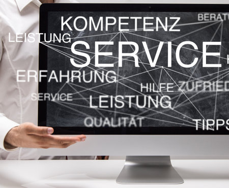 A 3D rendering of a monitor with business-related words in Germanの写真素材
