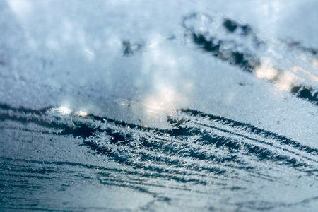 A closeup shot of a frosty and icy windshield on a cold winter dayの写真素材