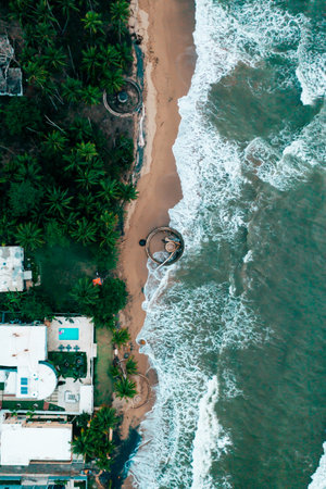 A bird's eye view of a beach and ruin of canon in Aguada, Puerto Ricoの写真素材