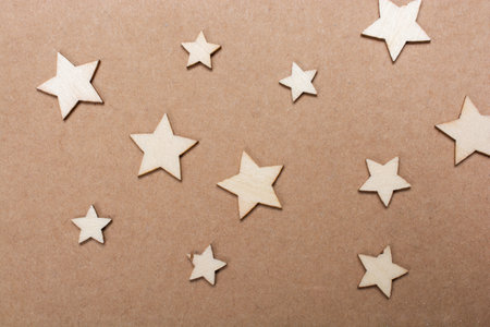 Many star-shaped pieces are on a cardboard surface.の写真素材