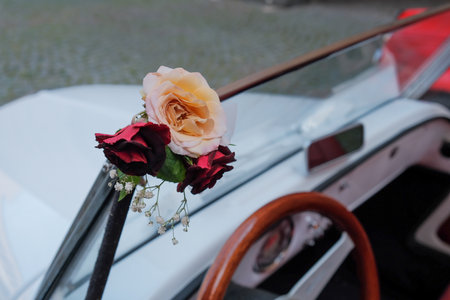 The wedding roses on a white car parked in the streetの写真素材