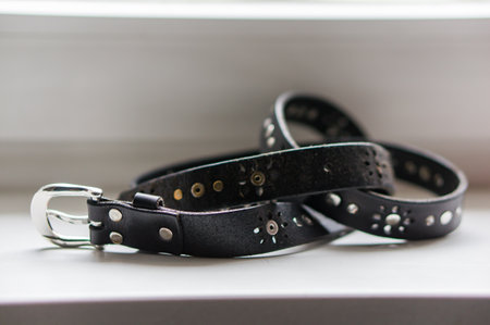 A selective focus shot of a black women's leather belt