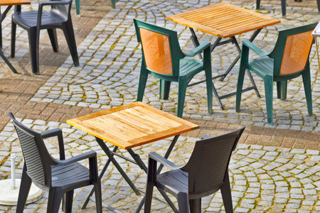 A beautiful shot of an outdoor cafe with tables and chairsの写真素材