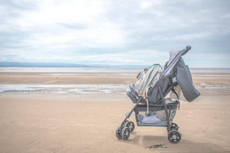 A closeup of a babies stroller left at the beach in Widerstand nest Franceの写真素材