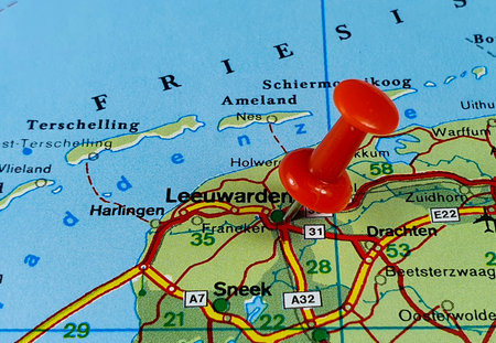 A Closeup of a red pin pointing the location on the map of Leeuwarden  city in the Netherlandsの写真素材