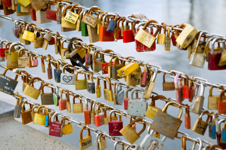 A beautiful shot of many locks attached to long chains on a seasideの写真素材