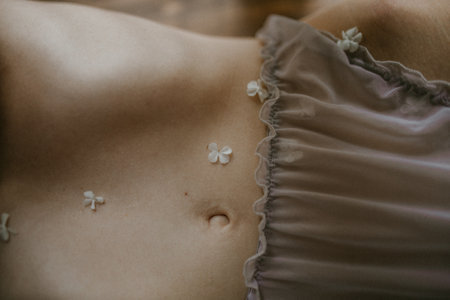 A closeup shot of small delicate flowers on a female bodyの写真素材