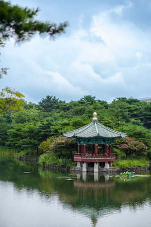 A vertical shot of a traditional building reflecting in a pond in South Koreaの写真素材