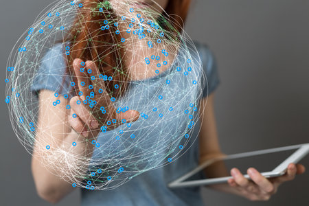 A businesswoman tapping on a 3D rendering of a global network hologramの写真素材
