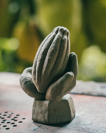 A stone sculpture of a cacao bean in handsの写真素材