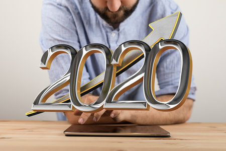 An abstract shot of a man's hand displaying 3D rendered 2020 successful business 
 performance icon