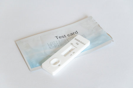 A closeup of a rapid COVID test with its pa on a white surfaceの写真素材