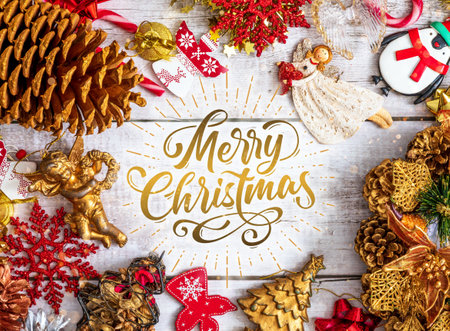 A top view of Christmas ornaments on a wooden surface with Merryの写真素材