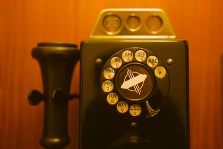 A closeup shot of a vintage phone on the wooden wallの写真素材