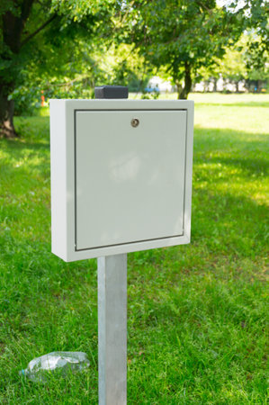 A vertical of a metallic box filled with bags for dog wast