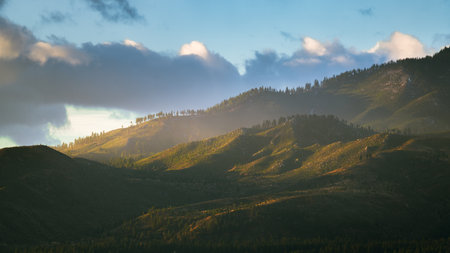 A gorgeous view of lush green hills under a bright cloudy sky at the Washoe Valley in Nevada during sunriseの写真素材