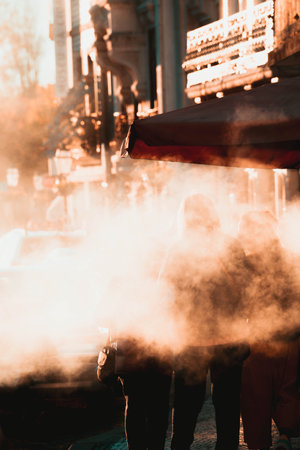 The smoke of the barbecue covering the view of customers of the street food venueの写真素材