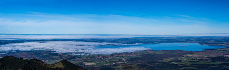 A panoramic view of a landscape with the Chiemsee lake on the background, Bayern, Germany