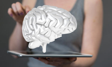 A female tapping on 3D rendered brain while holding a tablet