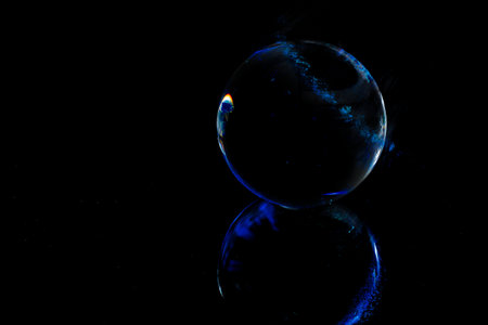 An abstraction of a mirrored sphere on a dark background