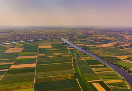 A birds-eye view of land and the Tisa river flowing through it in Serbia