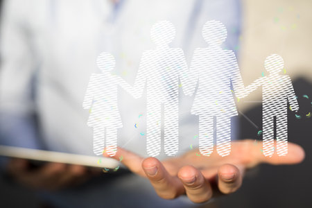 A hologram of a family floating on a person's handの写真素材