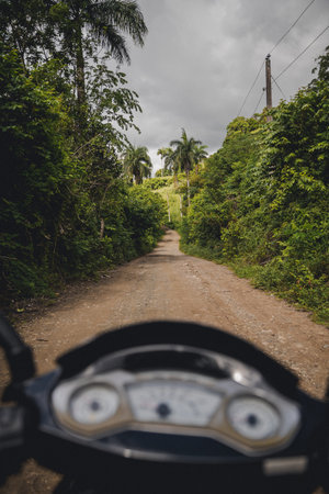 A point of view shot of a person driving a motorcycle on a rural roadの写真素材