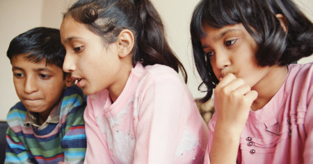 A closeup of the group of children watching something on the tablet.の写真素材