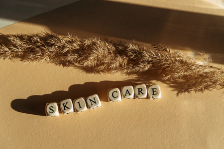 A closeup of wooden cubes with SKIN CARE wording on a tableの写真素材