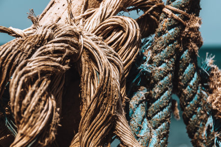 A  closeup shot of a fisher's boat ropes under a blue sky in Greeceの写真素材