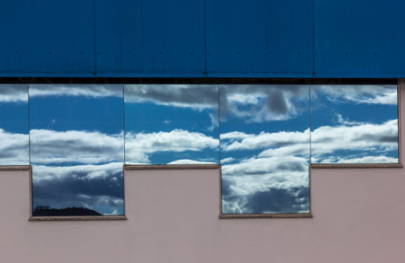 The clouds reflected in the glass