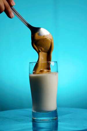 Dalgona Coffee Preparation, pouring the coffee into the milkの写真素材