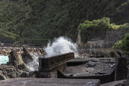 The view of the empty shore with the wave hitting against rocks.の写真素材